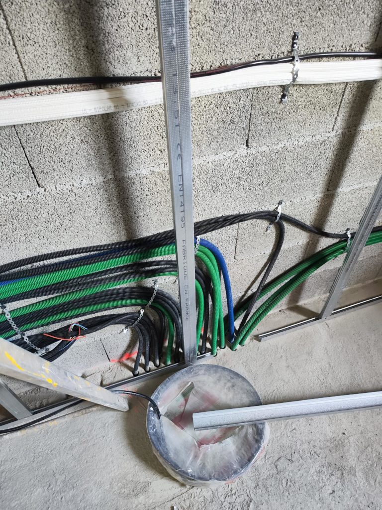 des gaines electrique et un tuyaux de climatisation tirer derriere un doublage